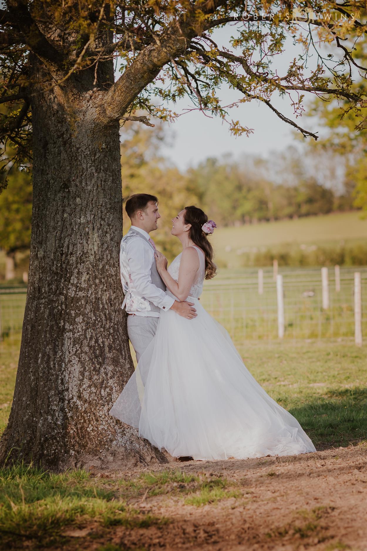 married couple under a tree 